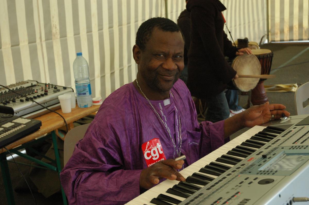 Un camarade Cgt du bâtiment joue de la musique Africaine à la fête des sans papiers de Massy.