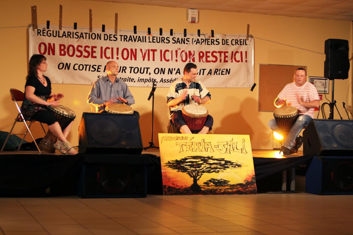 Groupe de percussionnistes devant une banderole