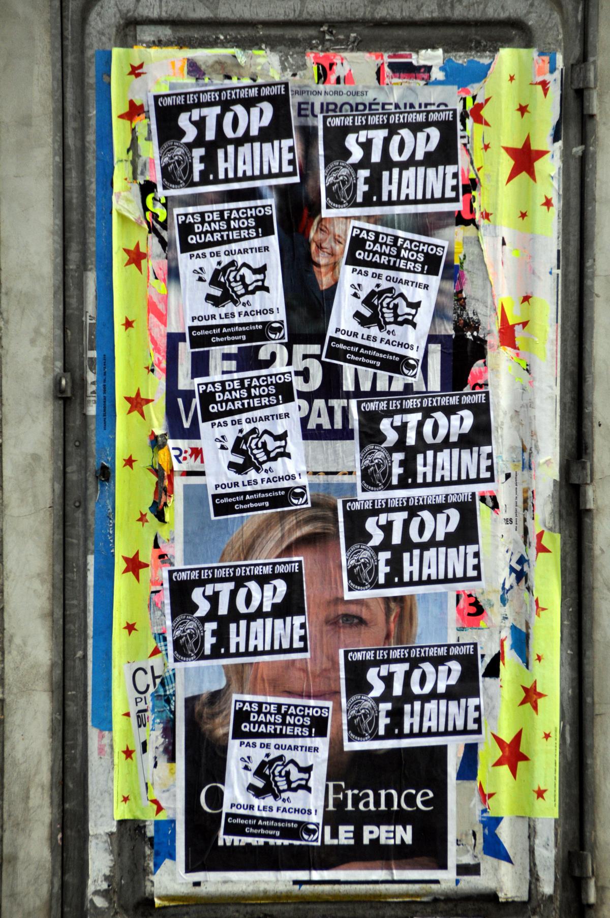 Affiches du FN recouverte par des affiches antifa